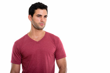 Obraz premium Studio shot of young handsome Hispanic man thinking while lookin