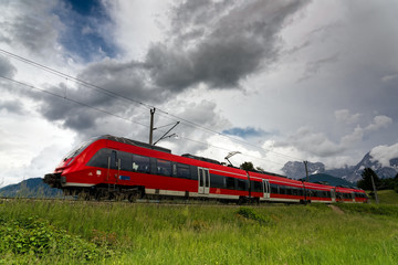 Naklejka premium Red train in the area of Bavarian Alps in Germany