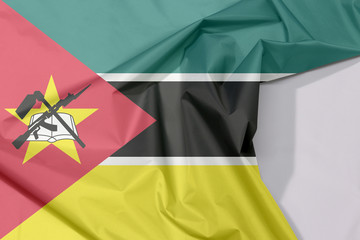 Mozambiquefabric flag crepe and crease with white space, horizontal green black yellow and small...