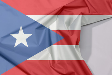 Puerto Rico fabric flag crepe and crease with white space, horizontal white and red bands with isosceles triangle based on the hoist side and white star.
