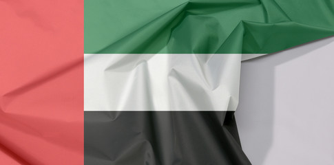 United Arab Emirates fabric flag crepe and crease with white space, green white and black with a vertical one fourth width red bar at the hoist.
