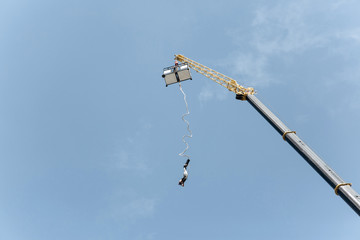 Bungee jumping with a crane. Active sport.
