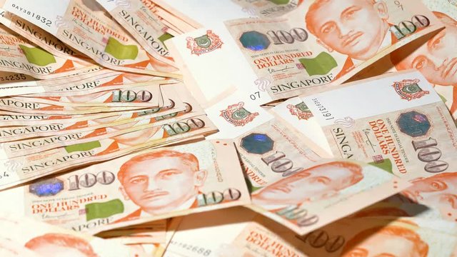 Full of 100 Singapore dollar notes SGD scattered around a table