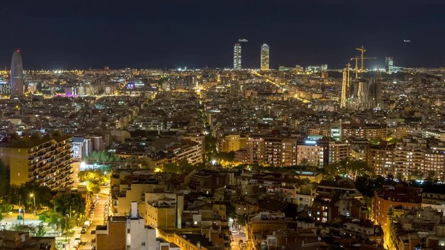 Barcelona city skyline. Panoramic view. Day to night time lapse video. City lights switch on. Panning left.