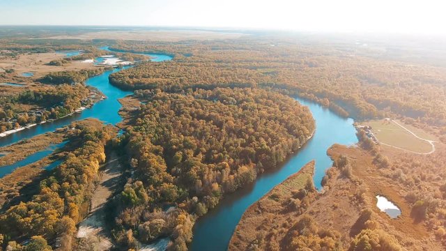Cinematic aerial view flight over meandering river