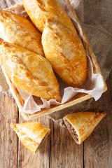Freshly baked Lithuanian lamb meat pies close-up. Vertical top view