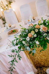Wedding restaurant banquet decorations with flowers. Wedding arch andnewlyweds table with white background.