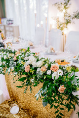 Wedding restaurant banquet decorations with flowers. Wedding arch andnewlyweds table with white background.