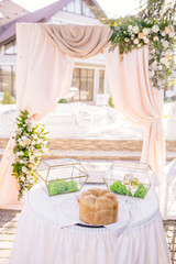 Wedding restaurant banquet decorations with flowers. Wedding arch andnewlyweds table with white background.