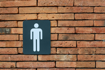 Public Men's Toilet Symbol on a brick wall