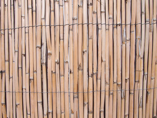 full frame cracked faded old bamboo fence background