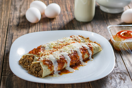 Delicious sliced pancakes with meat and tomato sauce