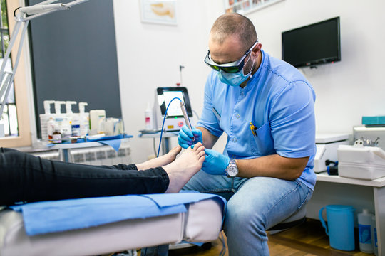 Toenail fungus treatment with foot laser at laser nail therapy clinic..