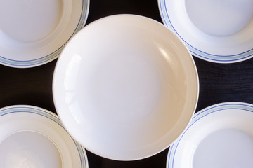 Empty Plates on Black Wooden Background
