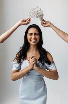 Attractive model receiving an award for winning beauty pageant. Portrait of shocked asian woman with emotional face celebration success, she gets main prize. Crowned queen of beauty concept. 
