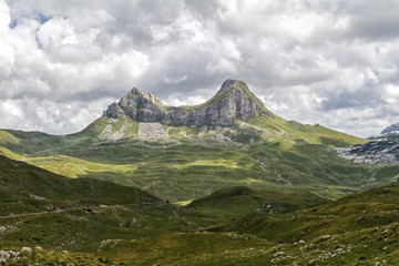 Beautiful landscape in Montenegro with fresh grass and beautiful peaks. Durmitor National Park in Montenegro part of Dinaric Alps. 