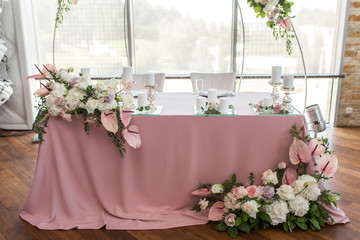 newlyweds banquet pink table decorated with fresh flowers and candles. Wedding decoration concept
