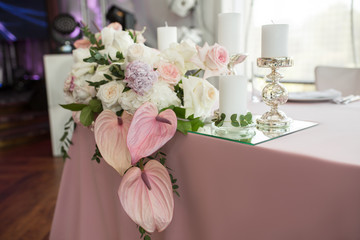 newlyweds banquet pink table decorated with fresh flowers and candles. Wedding decoration concept