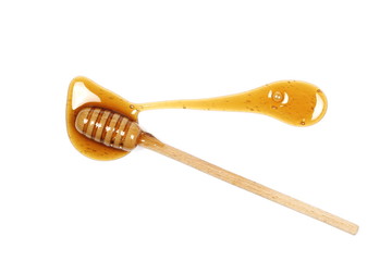 Honey and wooden dipper isolated on white background, top view