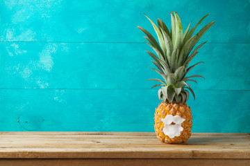 Christmas holiday concept with  pineapple as alternative Christmas tree on wooden table with copy space