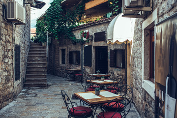 Naklejka premium Restaurant in calm street of the Old town, Budva, Montenegro