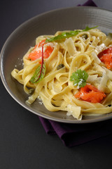 Pasta with salmon and sauce in bowl
