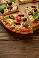 Pizza slice on wooden boards