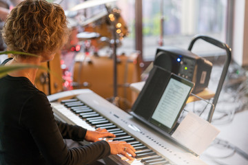 Woman playing electric piano in a concert 