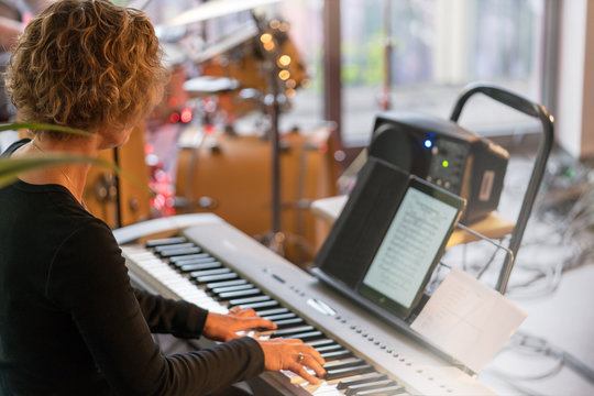 Woman Playing Electric Piano In A Concert 