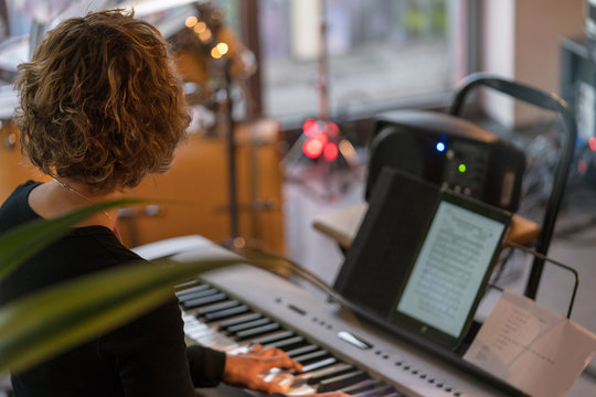Woman playing electric piano in a concert 