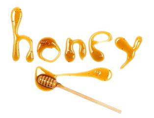 Honey letters and wooden dipper isolated on white background, top view