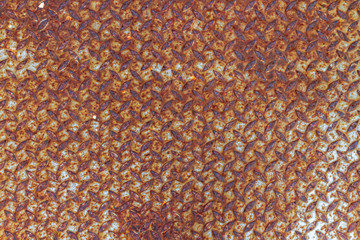 Background of scratching color and rusty on vintage steel checker plate with soft lighting.