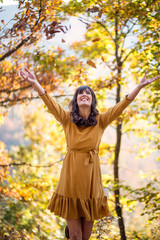 Portrait of pretty fashion young woman enjoying at autumn day