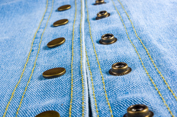 Blue washed faded jeans texture with seams, clasps, buttons and rivets