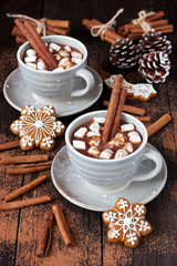 Mugs with hot chocolate  and gingerbread cookies on wooden table