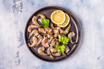 Raw shrimps with parsley and lemon.