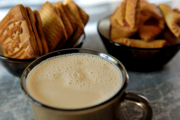cup of coffee with milk and cookies