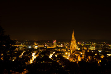 Fototapeta na wymiar Germany, Night lights over Freiburg im Breisgau and the minster