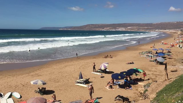 Beach with Chairs, Tourists, and Umbrellas