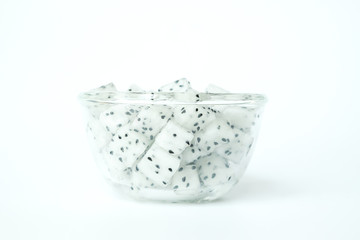 Dragon Fruit diced in a glass bowl on white background