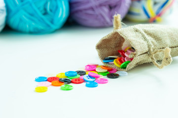 Colorful sewing buttons in small sack