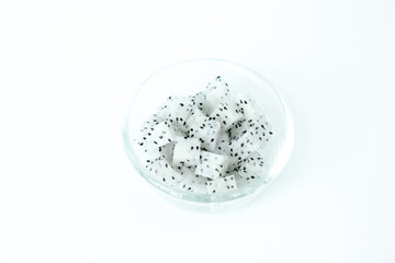 Dragon Fruit diced in a glass bowl on white background