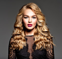 Fototapeta premium Blond woman with long curly beautiful hair.