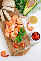 Ingredients for the preparation of bruschetta with shrimps and avocado