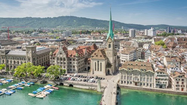 Aerial time lapse video of the Fraumunster Church and the Munsterbrucke stone bridge over the Limmat river in Zurich, Switzerland