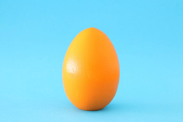 concept image of egg shape over blue pastel background. minimal an pop art concept.