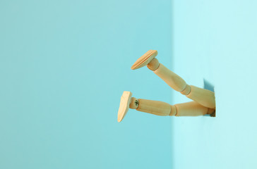 concept image of wooden dummy stuck upside down. stress and danger concept.