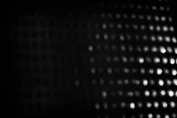 abstract background of black and silver bokeh lights.