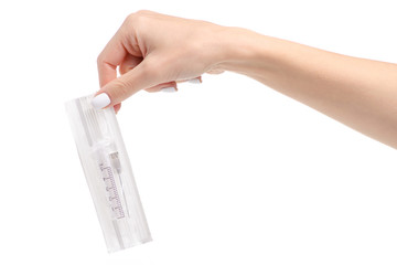 Syringe in package in hand on a white background. Isolation