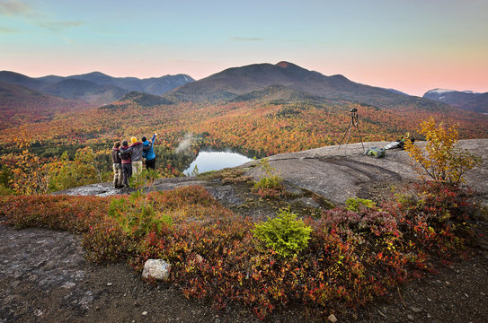 Group of hikers enjoying the viewpoint over Heart Lake in the Adirondacks